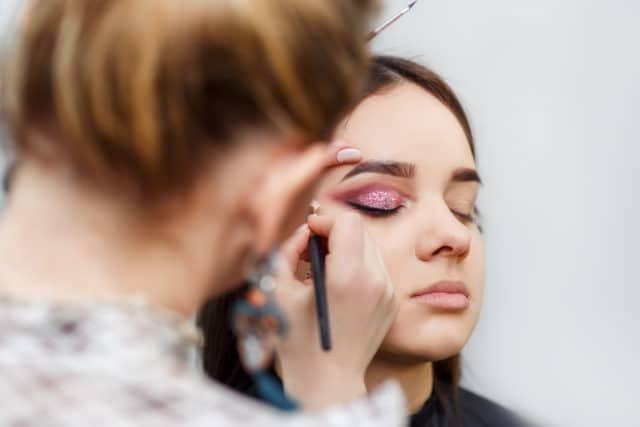 makeup artist doing glamour makeup